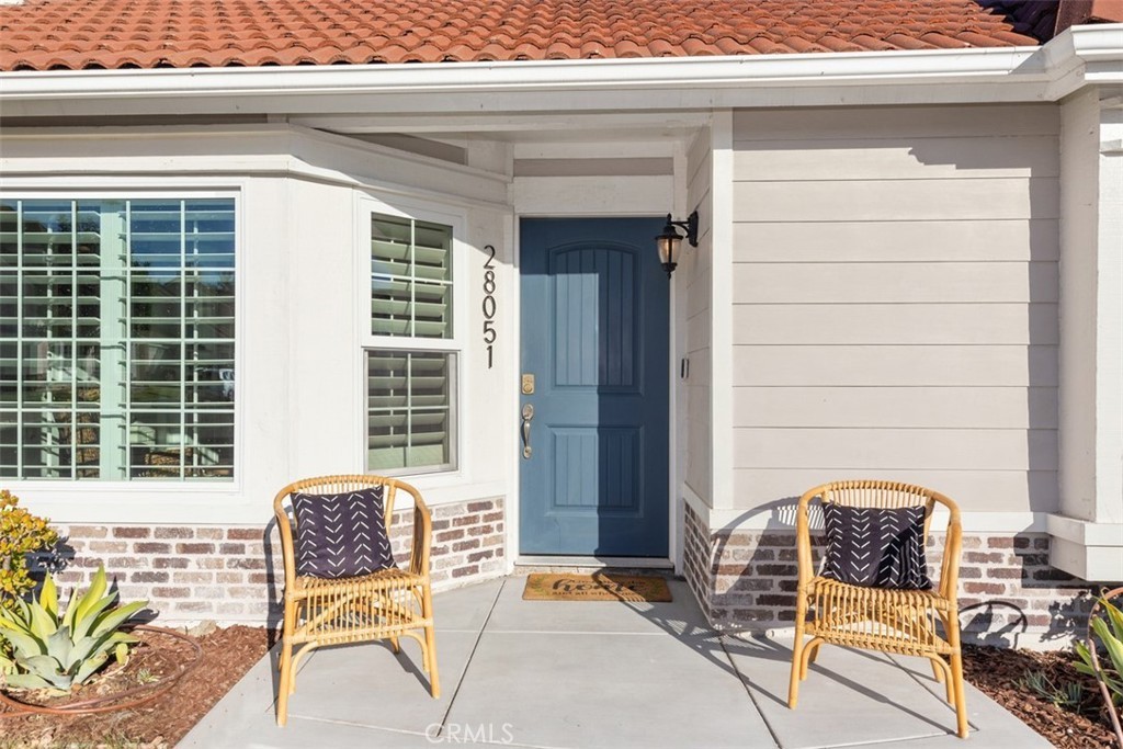 Restored vintage hardwood door with polished brass hardware in an Orange County home